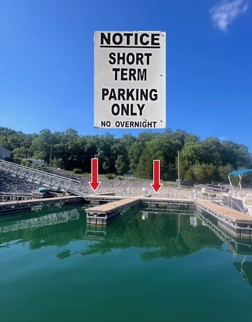 Dock slips on a calm day with a sign above saying short term parking.